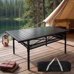 Black aluminum folding camping table with roll-up top and mesh storage basket