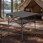 Black aluminum folding camping table with roll-up top and mesh storage basket