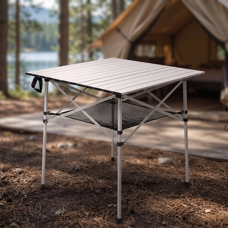 Black aluminum folding camping table with roll-up top and mesh storage basket