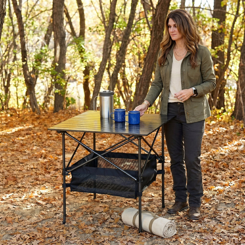 Woman setting drinks on an aluminum folding camping table outdoors
