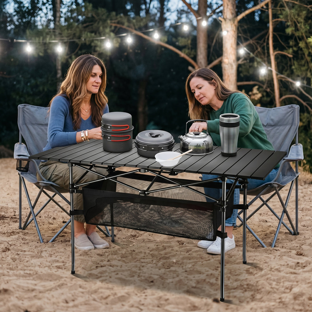 Woman setting drinks on an aluminum folding camping table outdoors