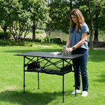 Woman setting drinks on an aluminum folding camping table outdoors