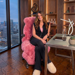 Tan genuine sheepskin rug draped over a modern office chair in a high-rise workspace
