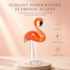 Hand-blown pink glass flamingo figurine with curved neck in sitting pose