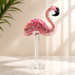 Hand-blown pink glass flamingo figurine with curved neck in sitting pose
