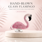 Hand-blown pink glass flamingo figurine with curved neck in sitting pose