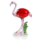 Hand-blown pink glass flamingo figurine with curved neck in sitting pose