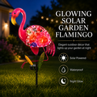 Hand-blown pink glass flamingo figurine with curved neck in sitting pose