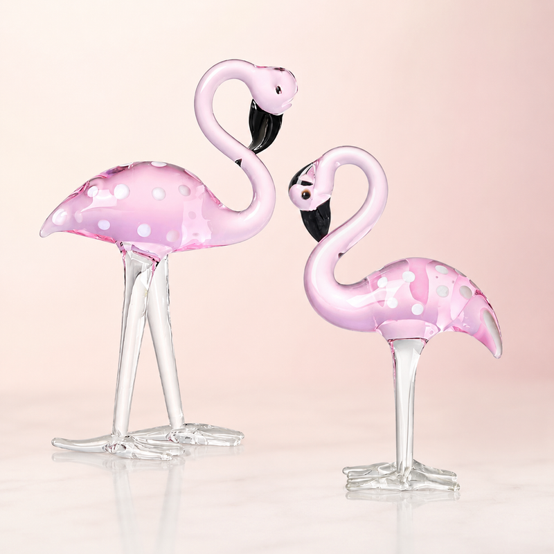 Hand-blown pink glass flamingo figurine with curved neck in sitting pose