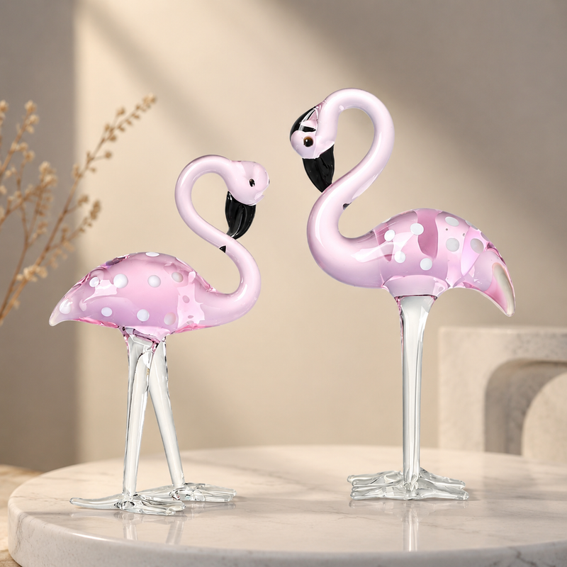 Hand-blown pink glass flamingo figurine with curved neck in sitting pose