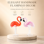 Hand-blown pink glass flamingo figurine with curved neck in sitting pose