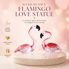 Hand-blown pink glass flamingo figurine with curved neck in sitting pose