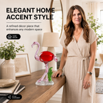 Glass flamingo figurine styled on a console table with flowers and books