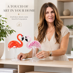 Glass flamingo figurine styled on a console table with flowers and books