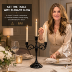 Gold candelabra with three lit taper candles on a styled formal dining table