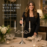 Gold candelabra with three lit taper candles on a styled formal dining table
