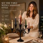 Gold candelabra with three lit taper candles on a styled formal dining table