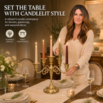 Gold candelabra with three lit taper candles on a styled formal dining table