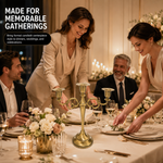 People gathered at a formal dinner table with a lit gold candelabra centerpiece