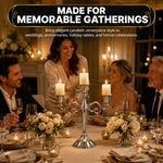 People gathered at a formal dinner table with a lit gold candelabra centerpiece