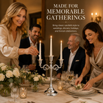 People gathered at a formal dinner table with a lit gold candelabra centerpiece