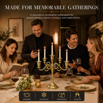 People gathered at a formal dinner table with a lit gold candelabra centerpiece