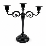 Gold three-arm metal candelabra candle holder on a white background