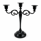 Gold three-arm metal candelabra candle holder on a white background