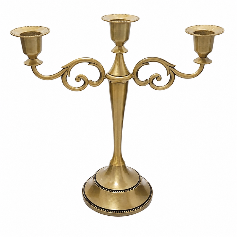 Gold three-arm metal candelabra candle holder on a white background