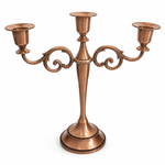 Gold three-arm metal candelabra candle holder on a white background