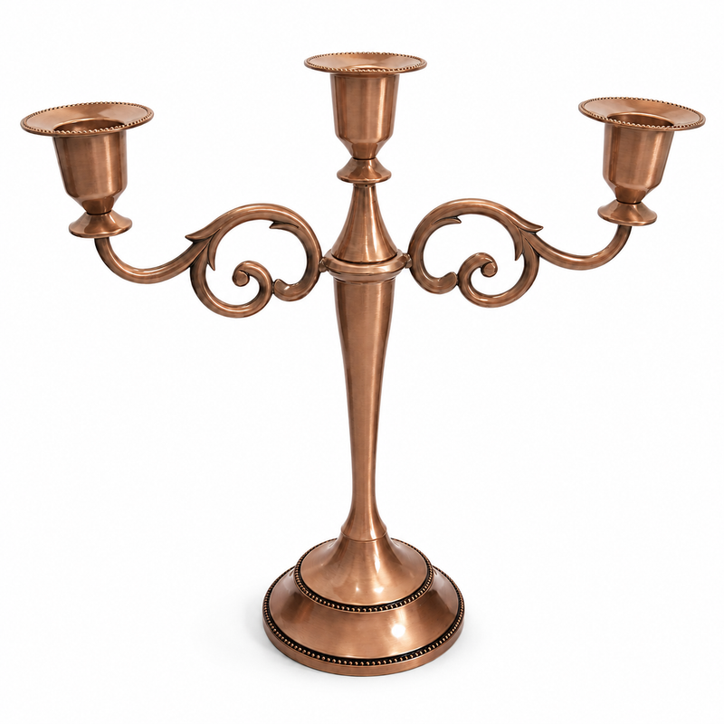 Gold three-arm metal candelabra candle holder on a white background