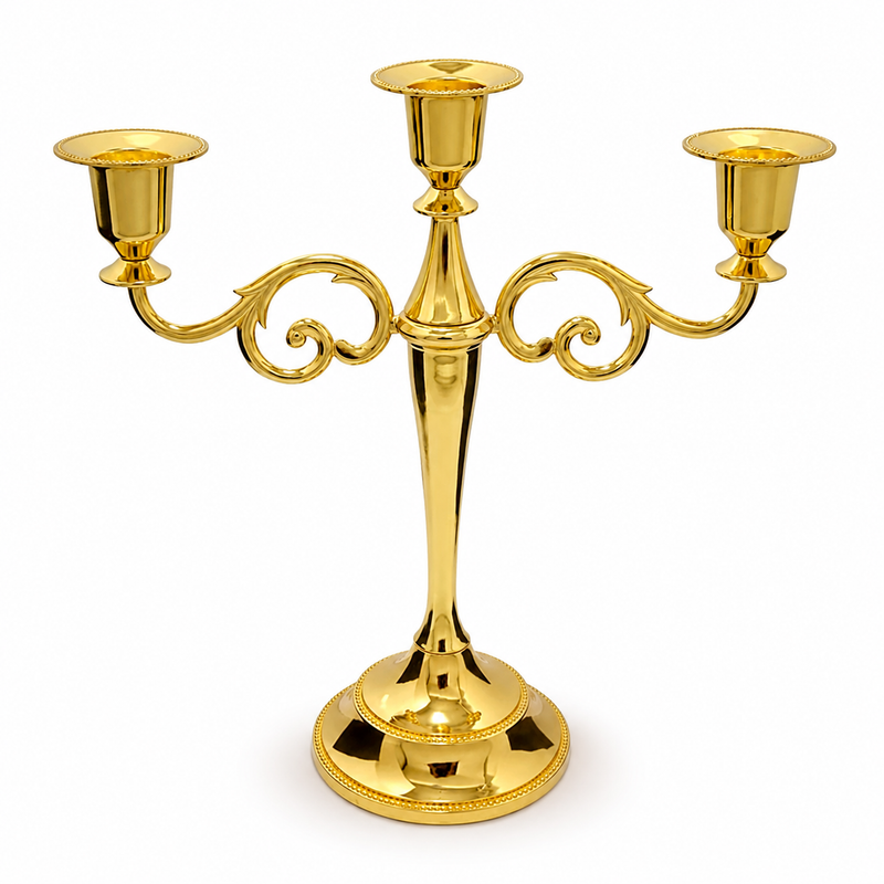 Gold three-arm metal candelabra candle holder on a white background