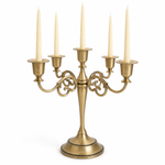 Gold three-arm metal candelabra candle holder on a white background