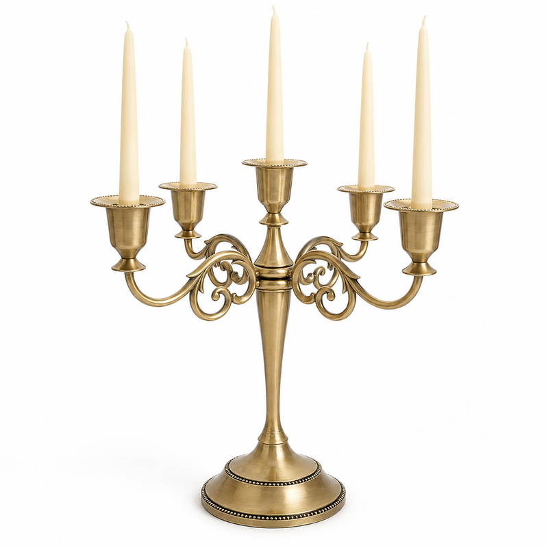 Gold three-arm metal candelabra candle holder on a white background