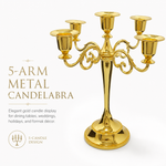 Gold three-arm metal candelabra candle holder on a white background
