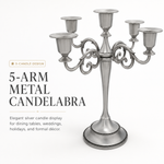 Gold three-arm metal candelabra candle holder on a white background