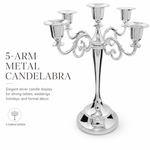 Gold three-arm metal candelabra candle holder on a white background