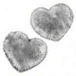 Rose red double attached heart shaped faux fur rug on a white background