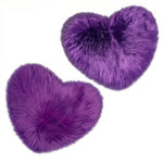Rose red double attached heart shaped faux fur rug on a white background