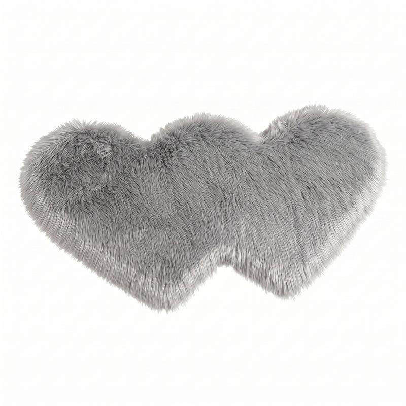 Rose red double attached heart shaped faux fur rug on a white background