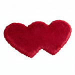 Rose red double attached heart shaped faux fur rug on a white background