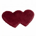 Rose red double attached heart shaped faux fur rug on a white background