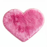 Rose red double attached heart shaped faux fur rug on a white background