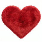 Rose red double attached heart shaped faux fur rug on a white background