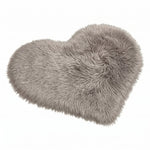 Rose red double attached heart shaped faux fur rug on a white background