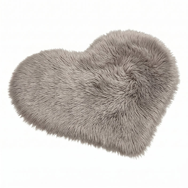 Rose red double attached heart shaped faux fur rug on a white background