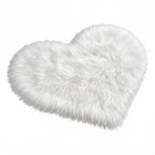Rose red double attached heart shaped faux fur rug on a white background
