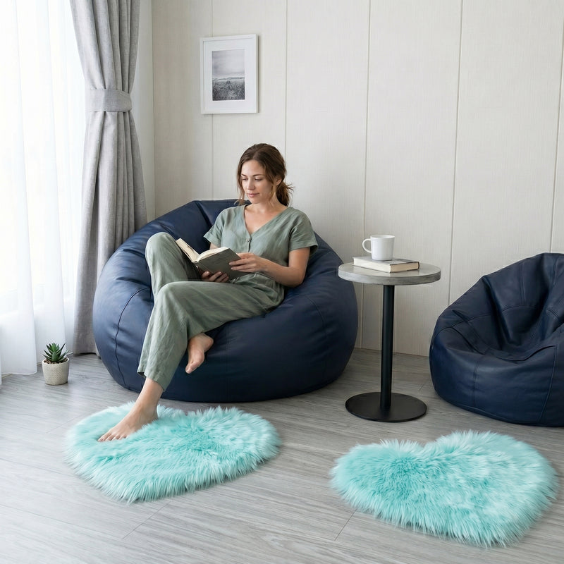 Pink heart shaped faux fur rug on a wood bedroom floor beside a bed