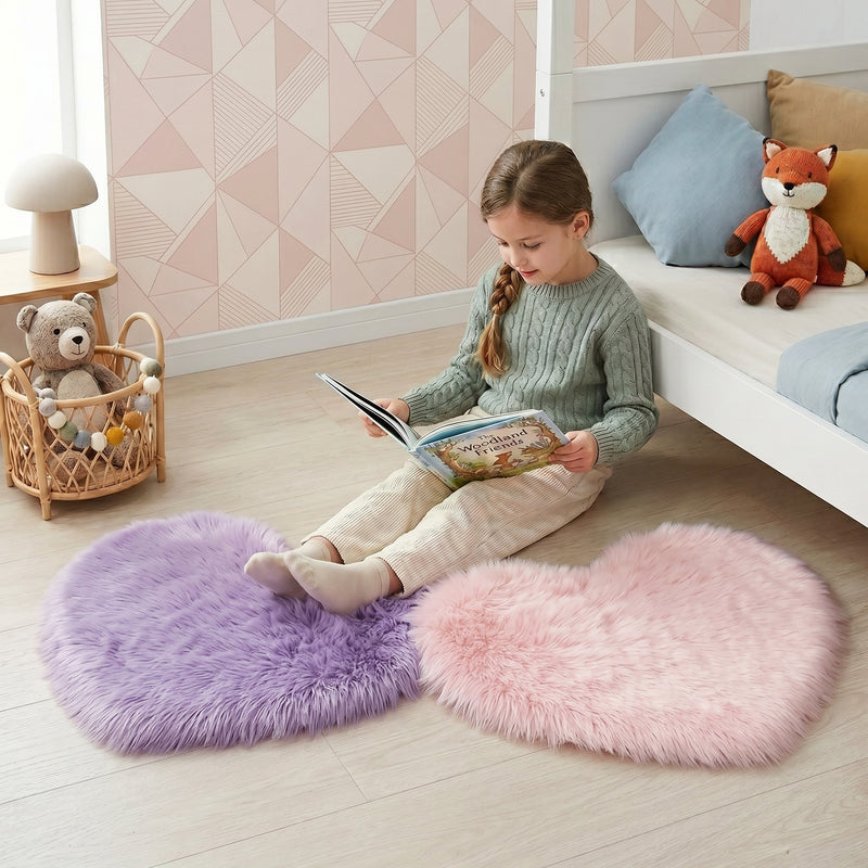 Pink heart shaped faux fur rug on a wood bedroom floor beside a bed