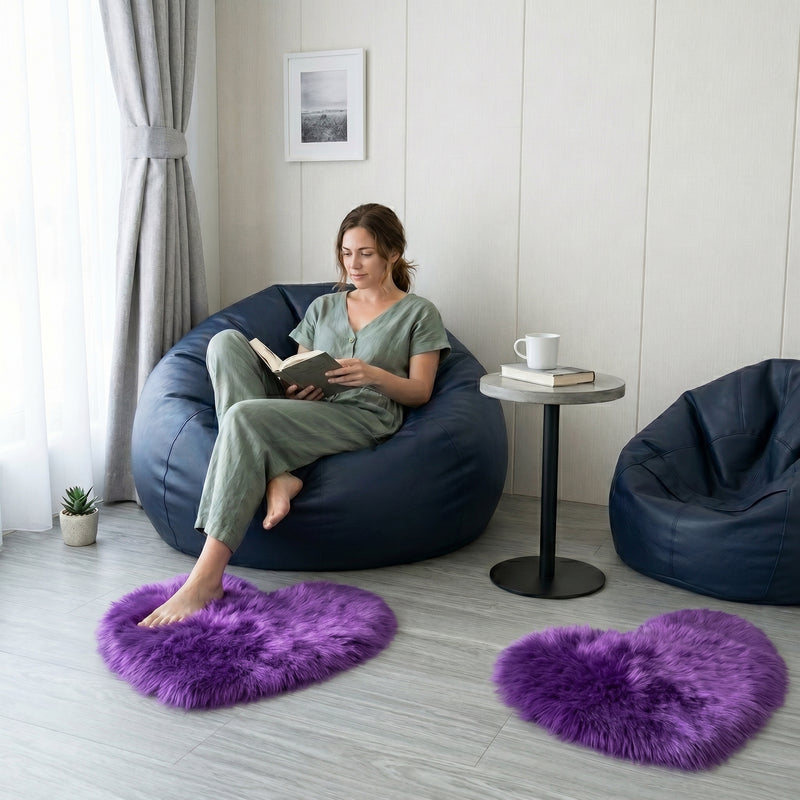 Pink heart shaped faux fur rug on a wood bedroom floor beside a bed